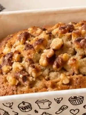 A banana walnut loaf in a floral tin