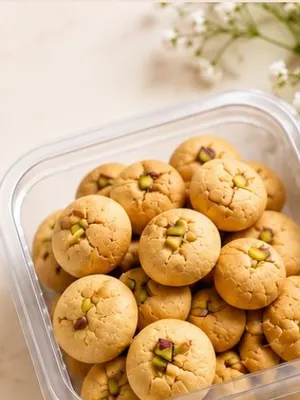 Round naan khatai biscuits in a clear box